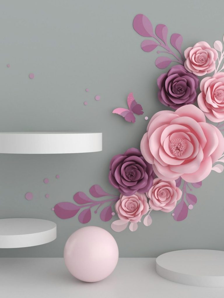 Floristik Design Rosa und lila Papierblumen dekorieren eine graue Wand neben einer weißen Kugel und Regalen.